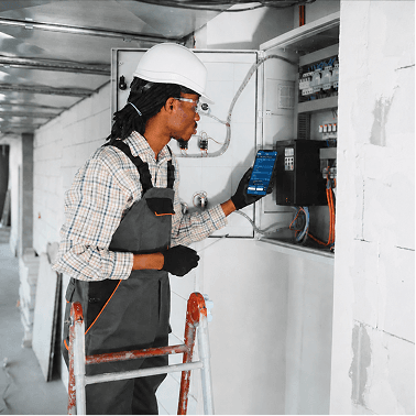 HVAC technician working on electrical panel