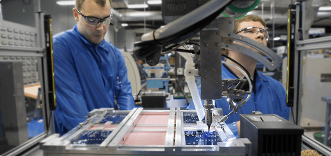 BAPI mechanical engineers inspecting a circuit board assembly