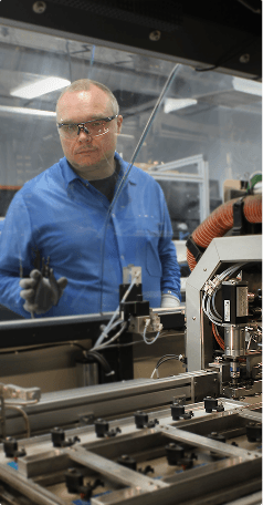 BAPI production technician working with wave soldering equipment